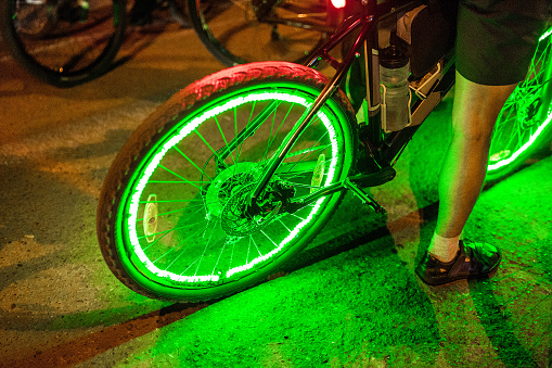 Bright neon lights and illumination on the wheel of a bicycle at night, the concept of safety of traffic in the dark