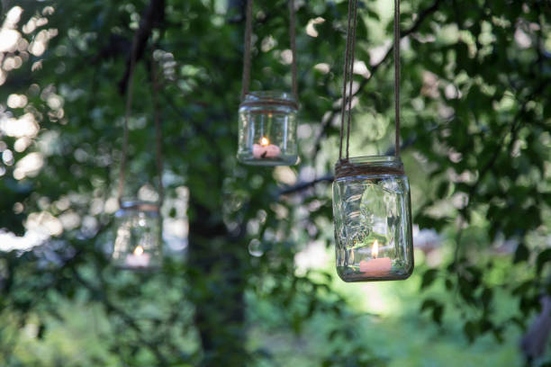 istock Hanging on the trees candle jars 1158619957