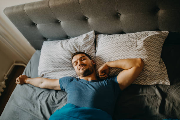 Man waking up Man waking up man sleeping on bed stock pictures, royalty-free photos & images