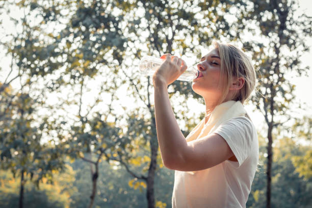 istock Beautiful girls drinking water after exhausting exercise. 1158620689