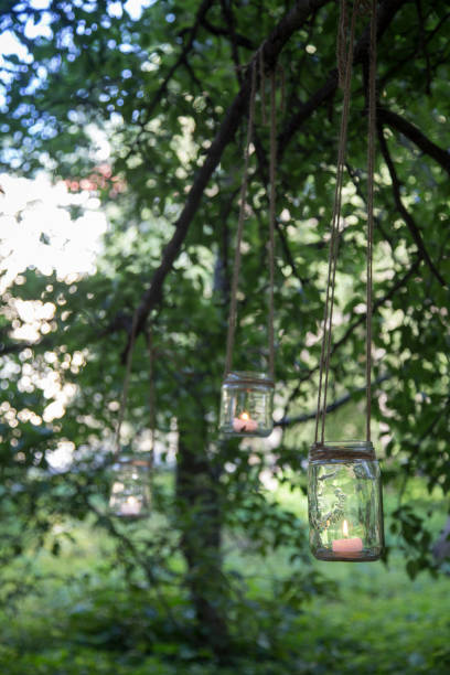 istock Hanging on the trees candle jars 1158620987