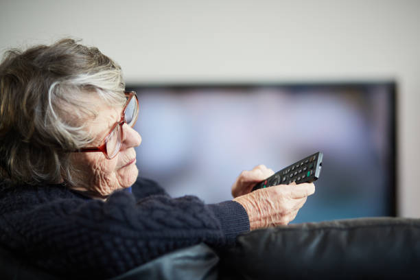 istock Senior woman irritated by her TV remote control 1158621038