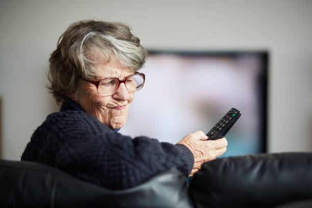istock Senior woman irritated by her TV remote control 1158621147