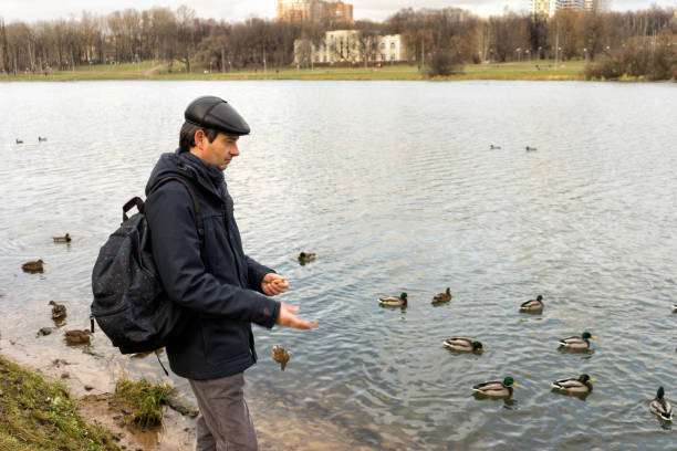 istock Handsome dark-haired middle-aged man in jacket, cap and backpack 1158623504