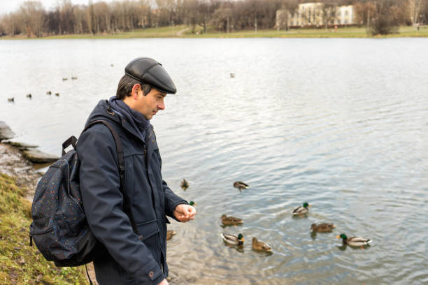 istock Handsome dark-haired middle-aged man in jacket, cap and backpack 1158623509