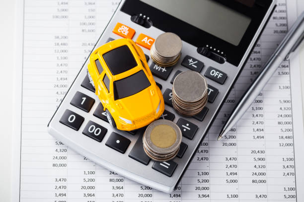 istock Car and coins on calculator 1158624875
