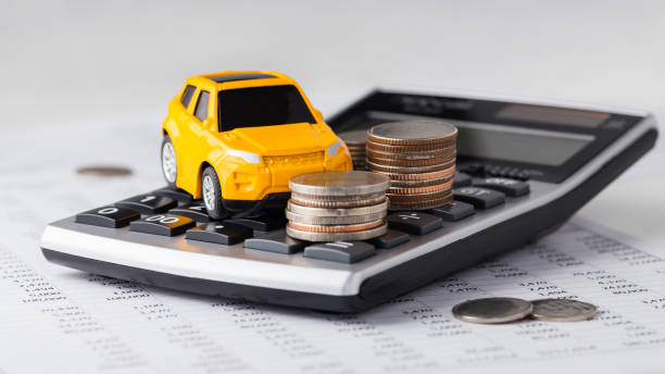 istock Car and coins on calculator 1158624899