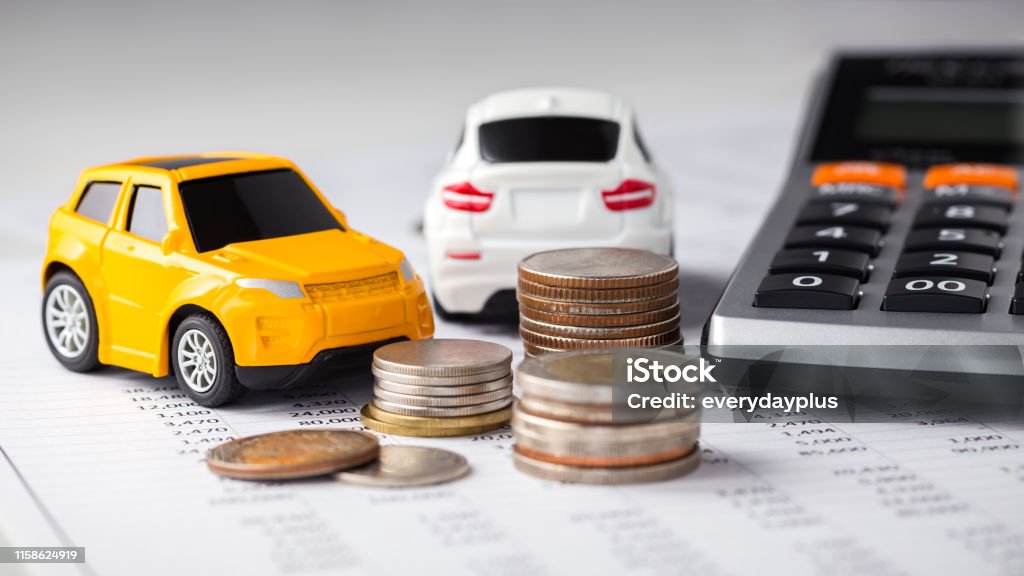 Cars, coins and calculator Cars and coins with calculator on financial statement Car Stock Photo