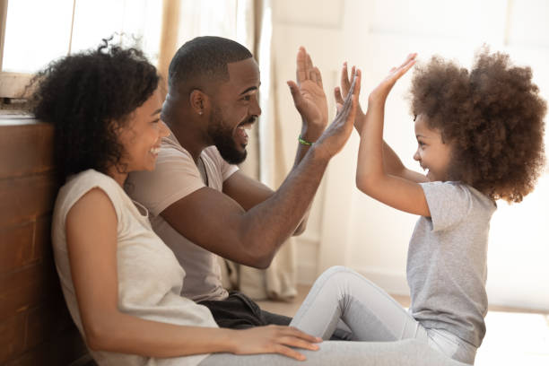 istock African kid daughter give high-five to daddy playing with parents 1158624948