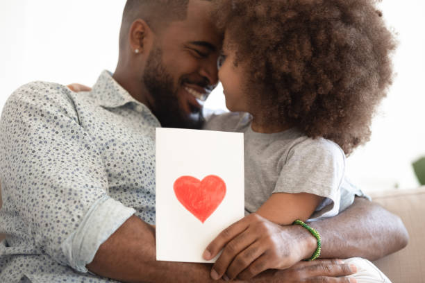 istock Black daddy hugging little daughter bonding holding greeting card 1158624997