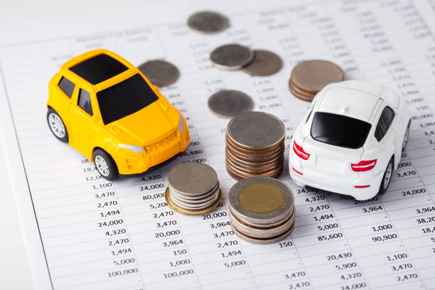 istock Cars and coins on financial statement 1158625193