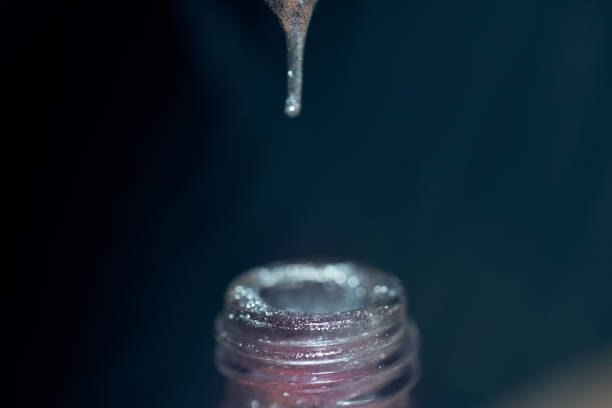 istock Dripping Silver Nail Polish Into Bottle 1158625277