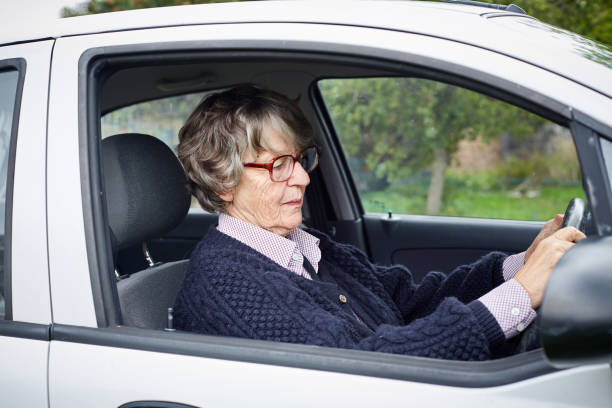 istock Senior woman driving a car 1158626790