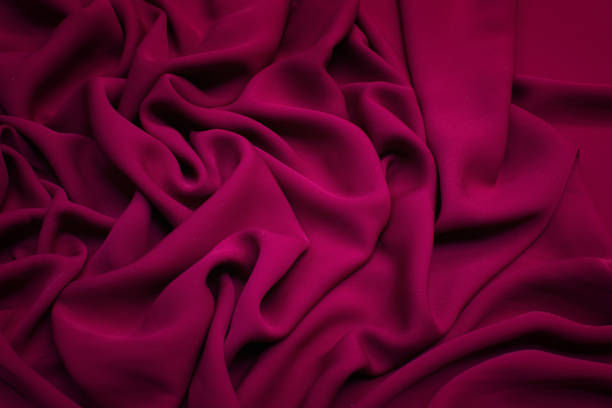 istock Silk fabric. The color is crimson. Texture, background, pattern. 1158627032