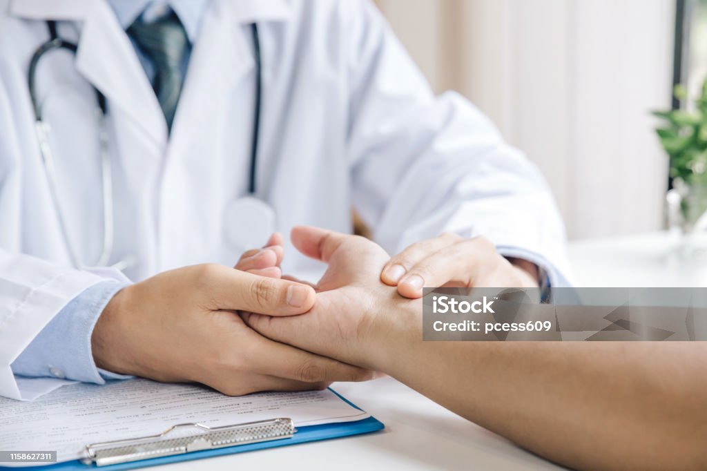 Extreme close-up of a doctor examining patient's hand in the medical office Orthopedics Stock Photo