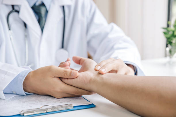 extreme close-up of a doctor examining patient's hand in the medical office - physical checkup imagens e fotografias de stock