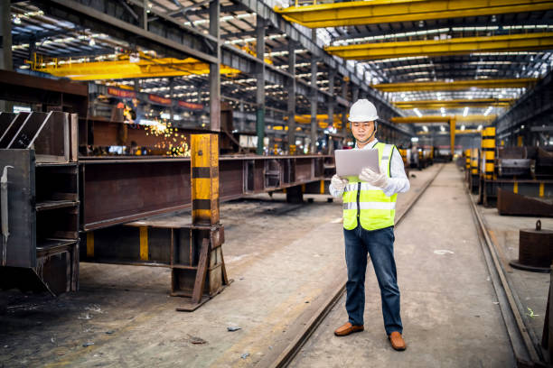 istock Asian engineer using a laptop in a factory 1158628249