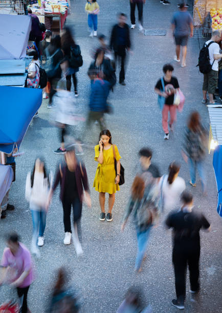 istock Woman using phone, motioned blurred market 1158628622