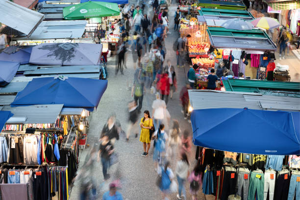 istock Woman using phone, motioned blurred market 1158628629