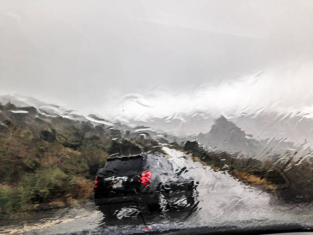 istock Driving at mountain strong rain extreme weather 1158629482
