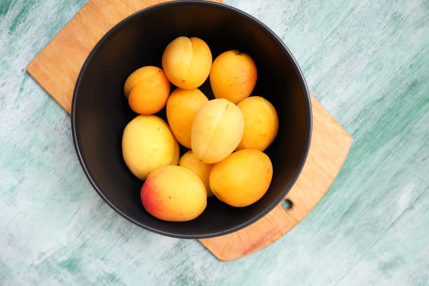 istock Sweet summer apricots in bowl. Top view. 1158629715