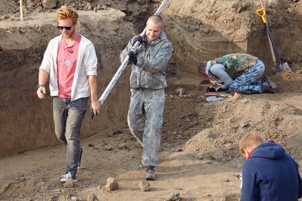 istock Archaeological excavations, the part of digger process. The archaeologists in a digger process, researching the tomb with human bones, drawing the human remains. 1158630867