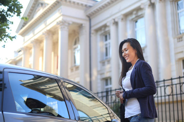 istock Asian woman entering a car 1158632327