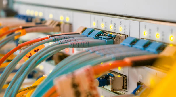 Internet wires are connected to the central router interfaces. There are many optical patchcards in the data center server room. Telecommunications cables are connected to the main server. los cables de internet están conectados a las interfaces del router central. hay muchas tarjetas de parche satusivas ópticas en la sala de servidores del centro de datos. los cables de telecomunicaciones están conectados al servidor principal.