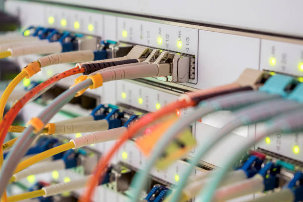 istock Internet wires are connected to the central router interfaces. There are many optical patchcards in the data center server room. Telecommunications cables are connected to the main server. 1158632365
