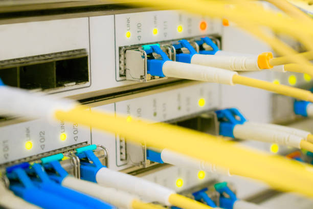 istock Yellow Internet wires are connected to the central router interfaces. There are many optical patchcards in the data center server room. 1158632375