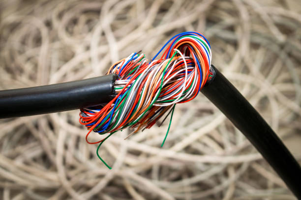istock Stranded telecommunications cable is twisted into a knot. The damaged cable is entangled in a large tangle. Broken isolation communication line. Problem concept with internet connection. 1158632423