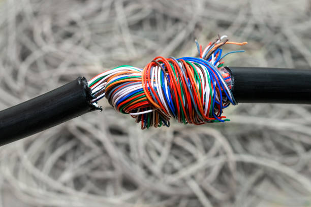 istock Stranded telecommunications cable is twisted into a knot. The damaged cable is entangled in a large tangle. Broken isolation communication line. Problem concept with internet connection. 1158632428