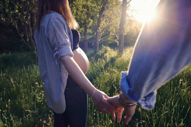 istock Couple walking through the field 1158632464