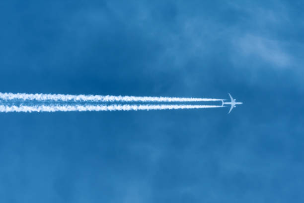 istock Jet aircraft flying at high altitude with contrails. 1158632599