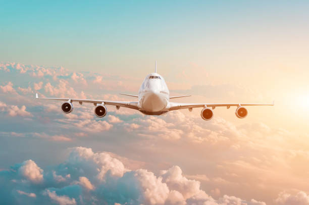 istock Large passenger plane with four engines flies in the sky at sunset. 1158632860