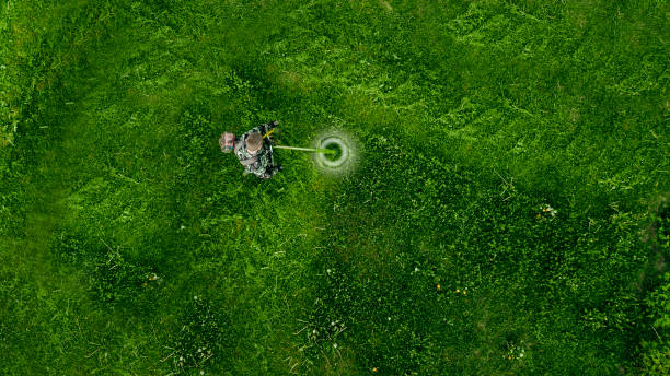istock Top view man worker cutting grass with lawn mower. 1158634008