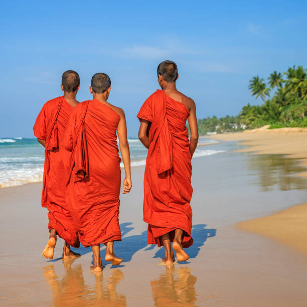 istock Sri Lankan young buddhist monks walking on the beach, Ceylon 1158634185