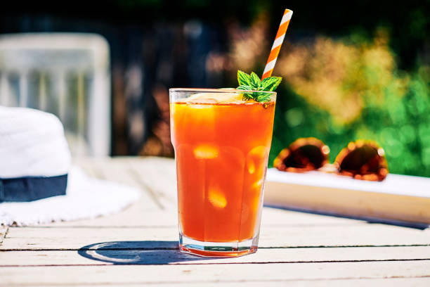 istock Summer Scene, Iced Tea with Lemon and mint on a garden table in bright sunshine. 1158634321