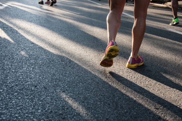 istock Runners feet running on road close up on shoe 1158636834