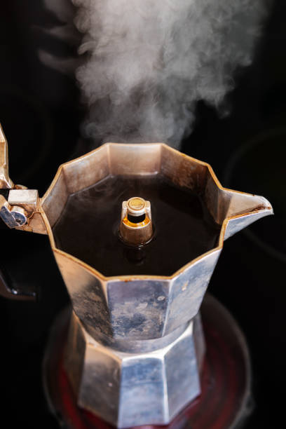istock Freshly brewed coffee with white steam in a mocha pot 1158638201