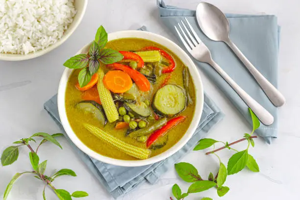 Vegan Thai Green Curry with Rice, Garnished with Thai Basil, Directly Above Photo. Traditional Thai Food Photography