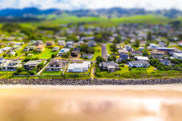 An aerial tilt/shift view of holiday houses on the beachfront at Waihi Beach on New Zealand's Coromandel Peninsula.