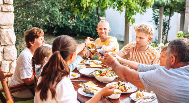 istock Big family have a dinner on garden terrace 1158641811