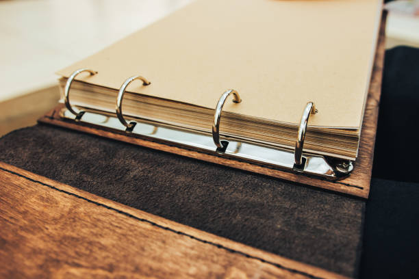 istock An open book of wood and leather. ring notebook mechanism. 1158641890
