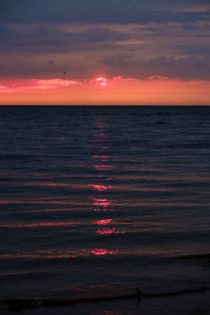 istock dramatic colorful clouds over sandy beach at the sea with blue sky 1158642523