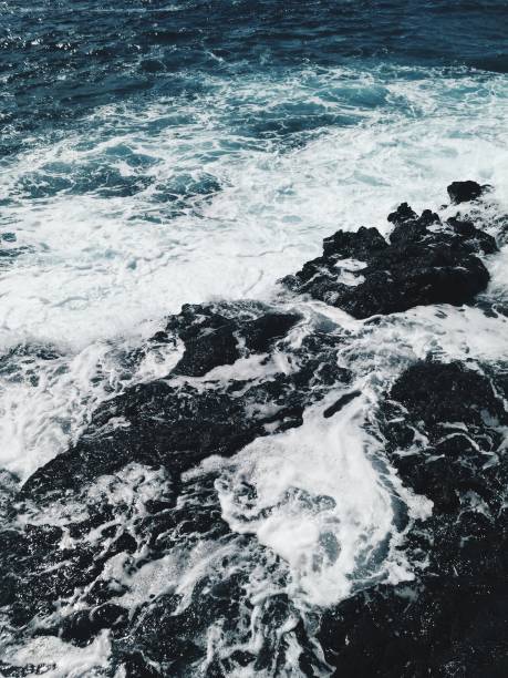 istock Foamy waves at ocean shore at sunset 1158643920