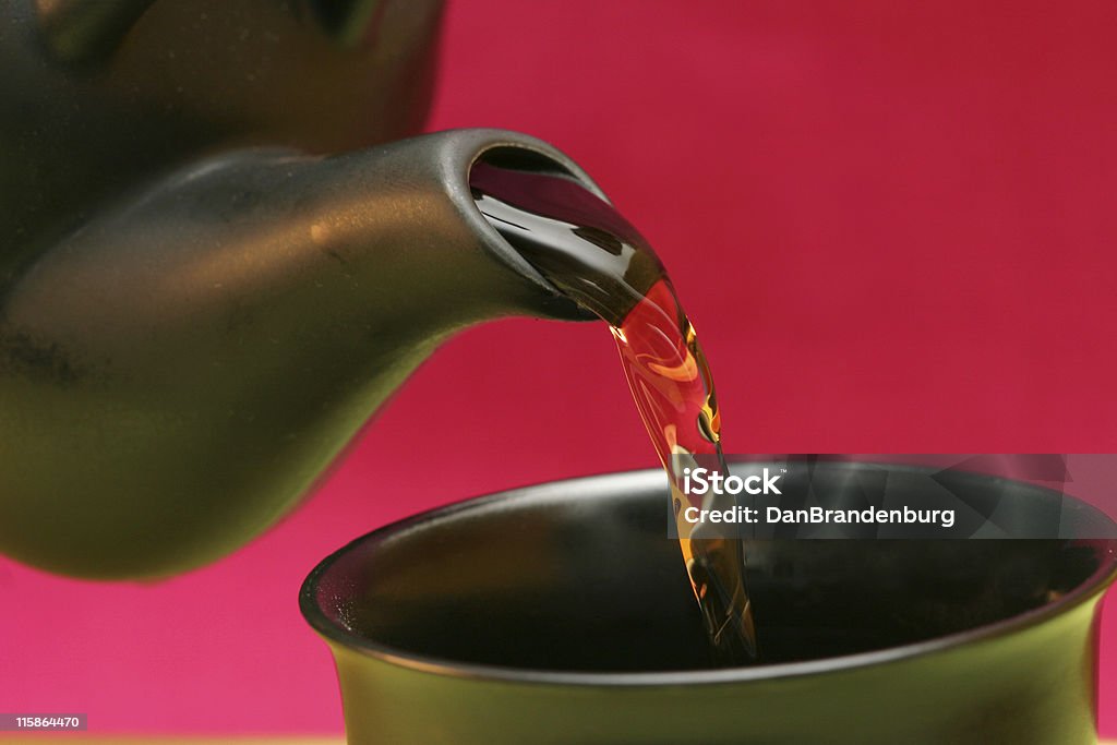 Pouring Tea pouring tea from the pot to the cup... Antique Stock Photo