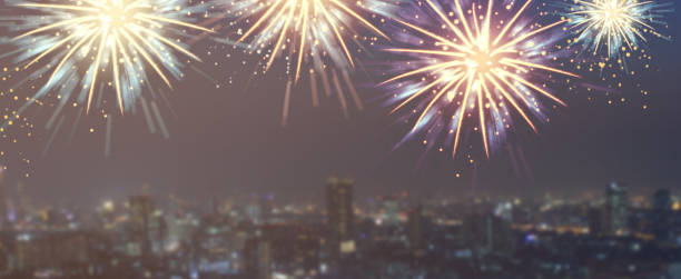 istock show group of exploding fireworks bright light colorful and falling fire glitter on blur city buildings panoramic view background for happy new year,diwali,labor's day ,independence's day and malaysia's day concept 1158646001