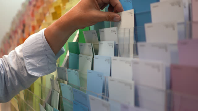 Close up of woman looking at color samples in a hardware store