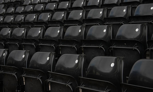 istock Close up of rows of empty black seats in stadium 115865357